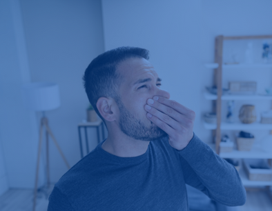 Man holding nose due to smell coming from fireplace